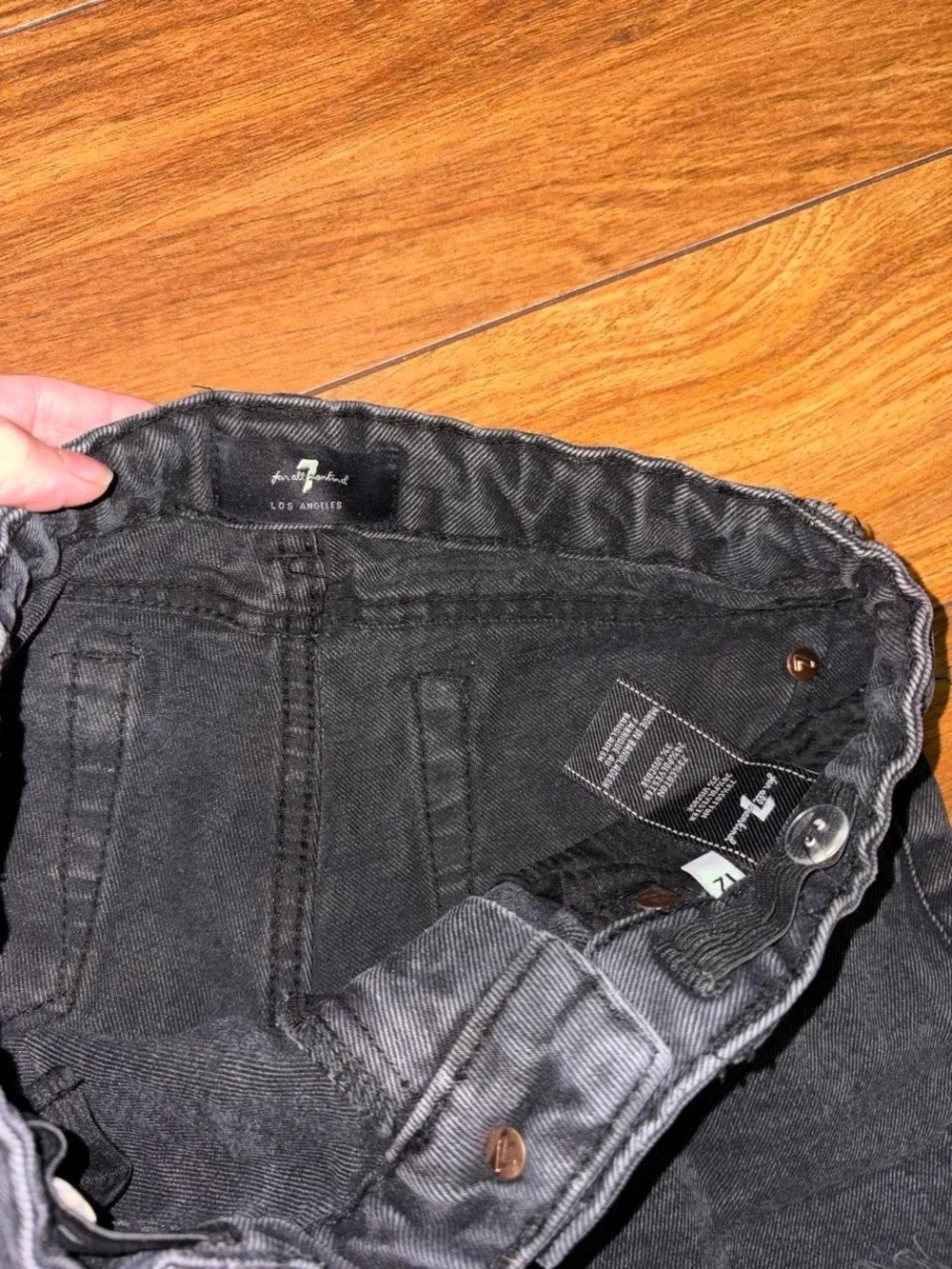 Black denim shorts with a distressed look